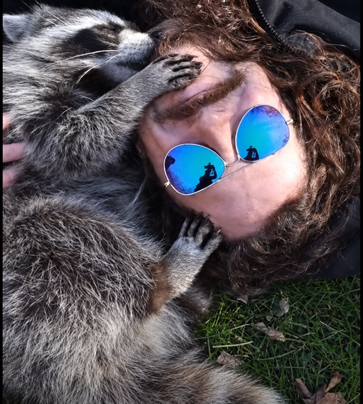 Louka Berman lying on the grass as Pepper touches his forehead and chin